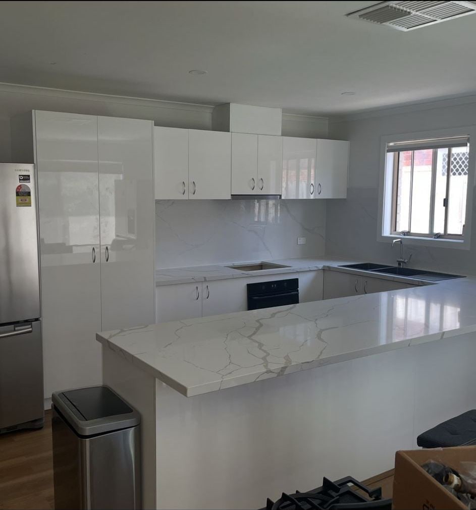 Renovated Melbourne kitchen with marble splashback and stone benchtops