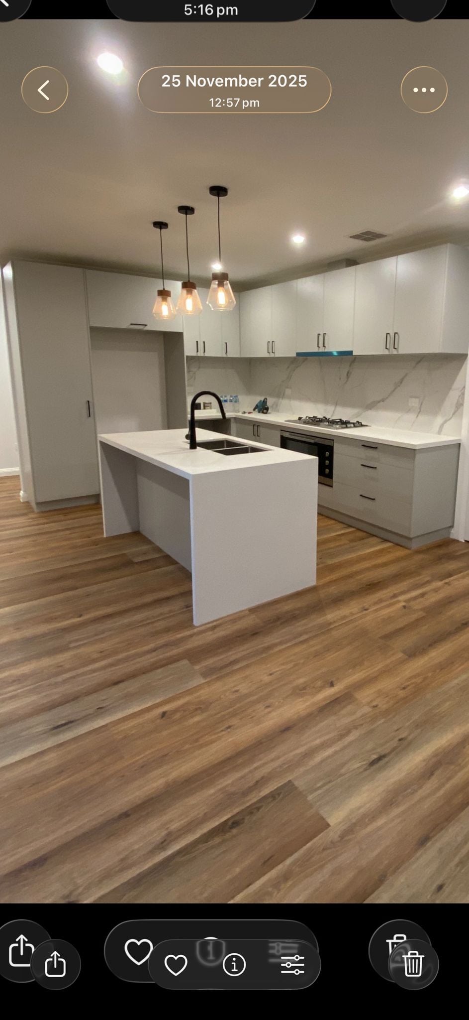 Open-plan renovated Melbourne kitchen and living with timber floors