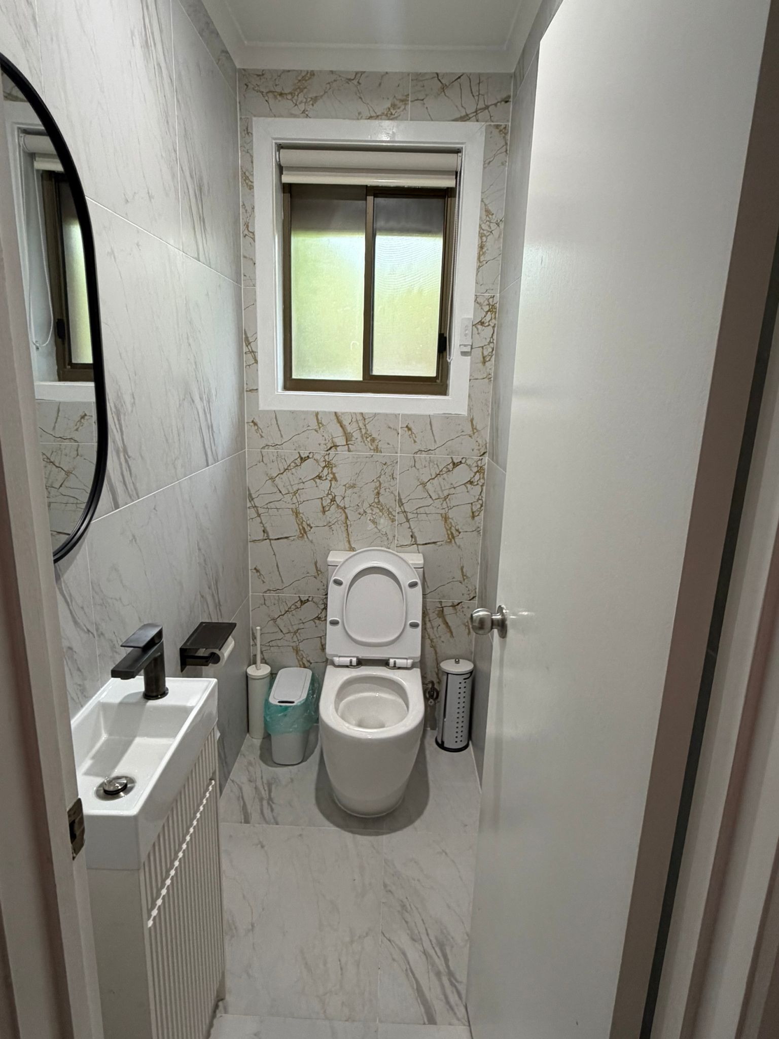 Powder room in gold-veined marble tile