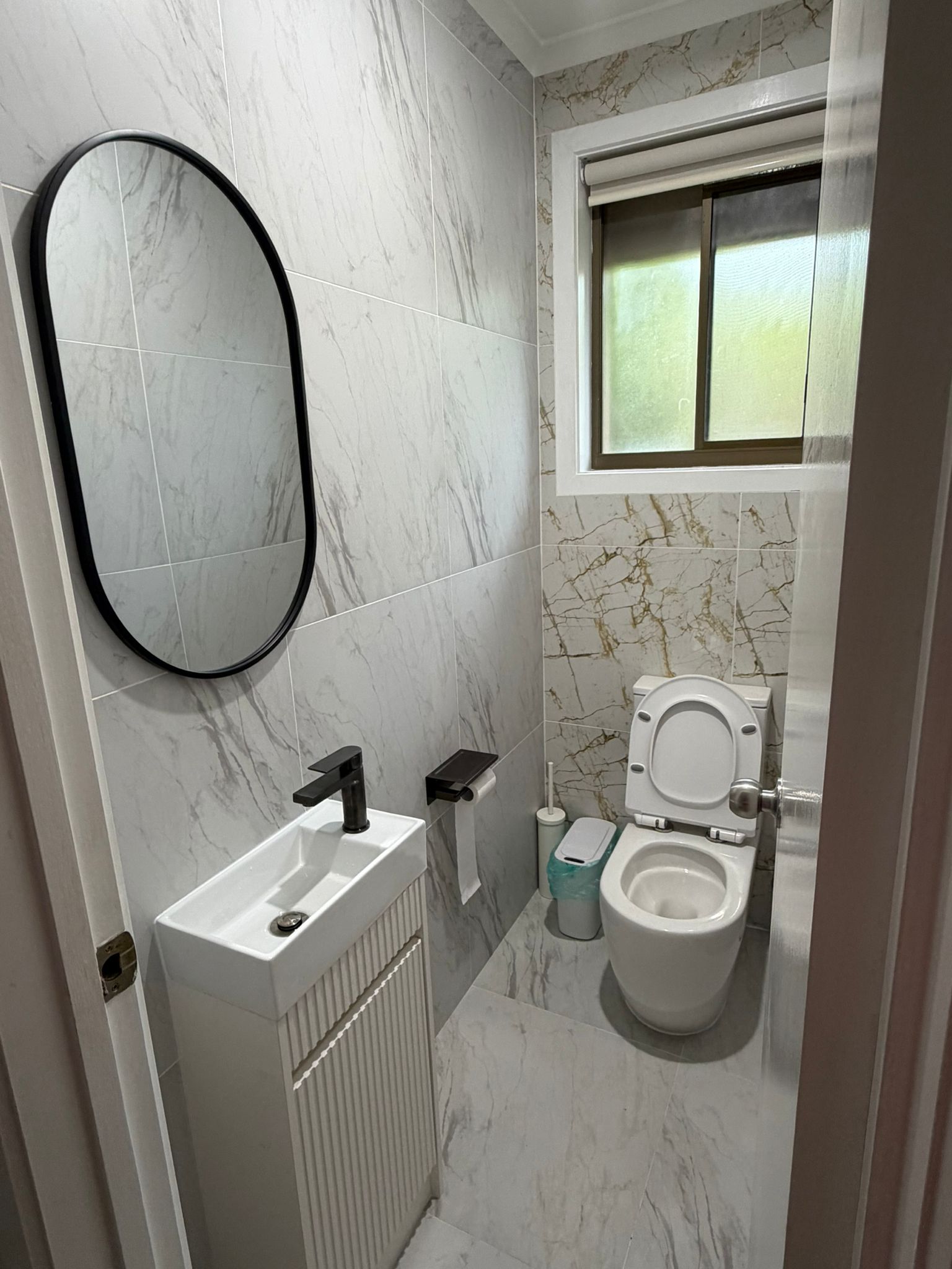 Built In project - Powder room in gold-veined marble tile